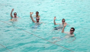 Caribbean guests wave swimming into the Soggy Dollar Bar in the British Virgin Islands